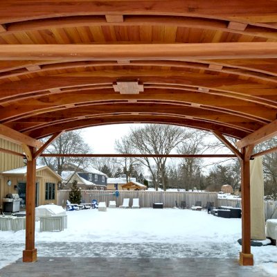 Backyard Pavilion Kits (Options: 15' L x 18' Arc W, California Redwood, 2 Post Electrical Wiring Trims, 4-Post Anchor Kit for Concrete, 1 Ceiling Fan Base, No Privacy Panels, 4 Curtain Rods, 9 ft Post Height, Transparent Premium Sealant). Photo Courtesy of M. McDonald of Lake Barrington, Illinois.